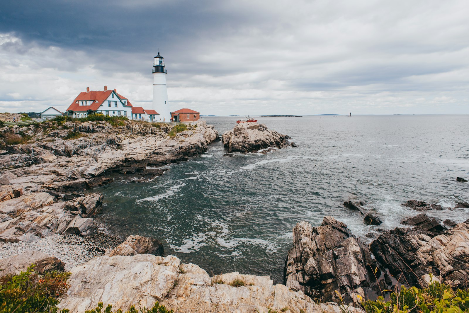A lighthouse on the Maine coast seen from a small boat